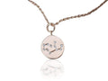 Rose gold necklace with a circular pendant featuring a star design on a white background