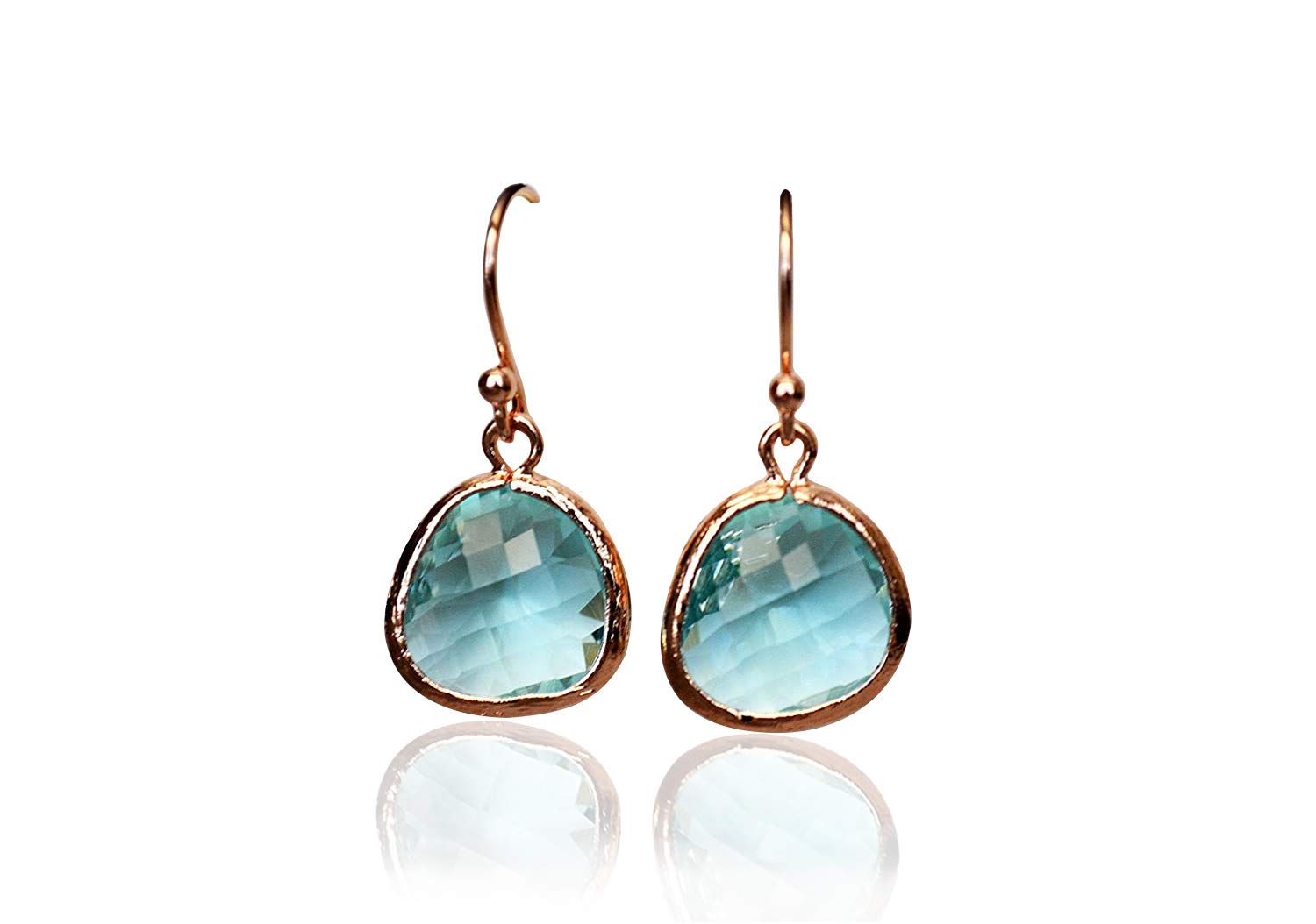 Pair of earrings with blue gemstones and gold-colored settings on a white background