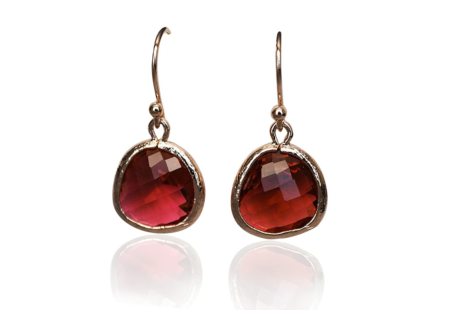 Pair of earrings with red gemstones on a white background