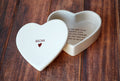 Heart-shaped ceramic box with 'Mom' and a heart on the lid, and text on the inside bottom.