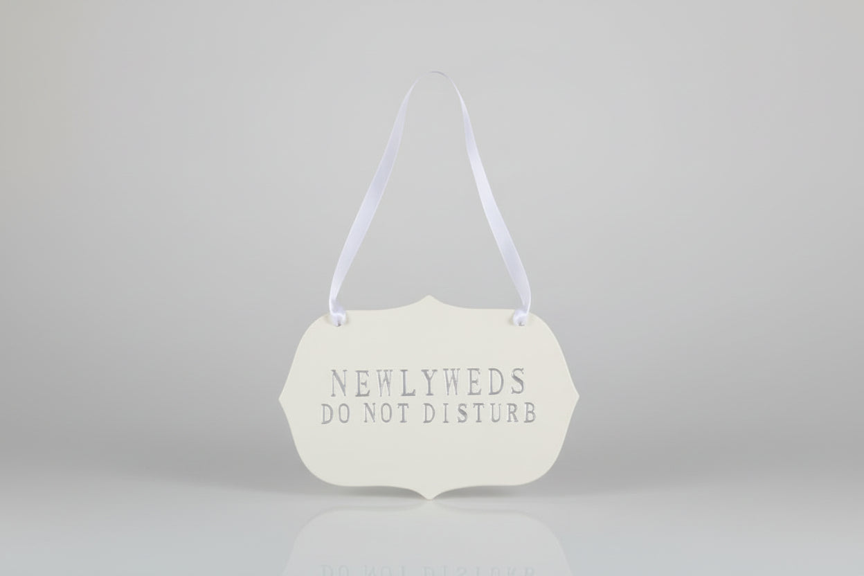 Decorative handmade ceramic sign  'NEWLYWEDS DO NOT DISTURB' text.