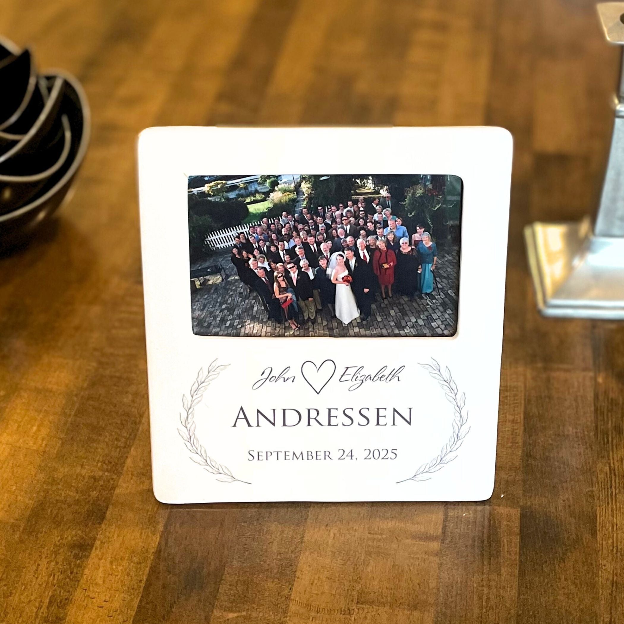 Personalized photo frame with a wedding photo on a wooden table