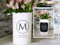 White vase personalized with last name and initial, with a close-up of the back showing text.